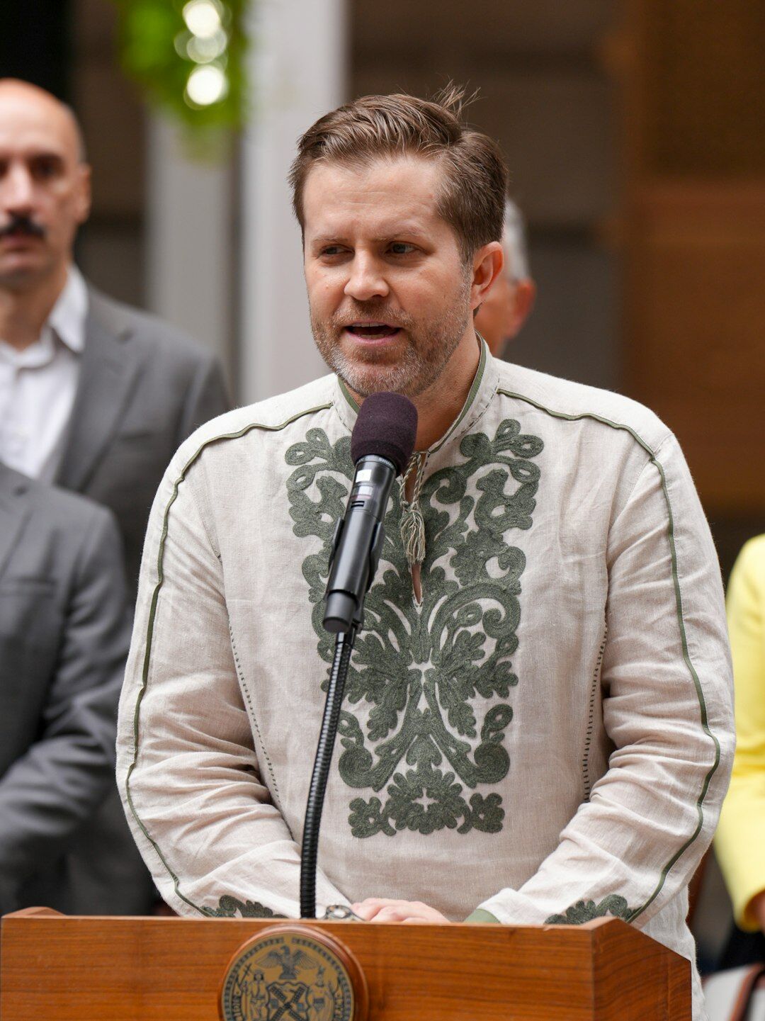 Speaker passionately presenting an argument at a podium