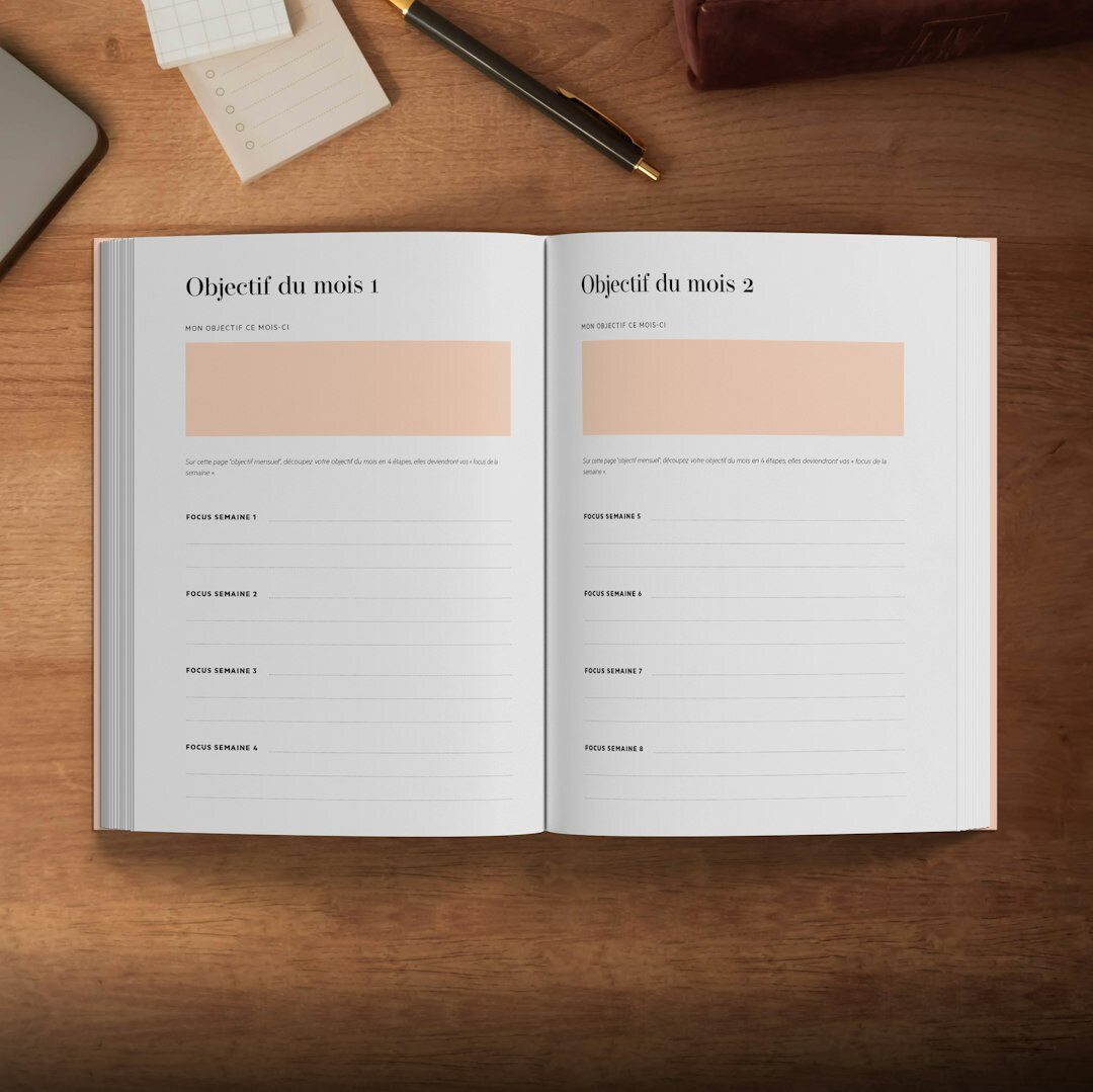 Open notebook with argument diagrams and a pen on a desk