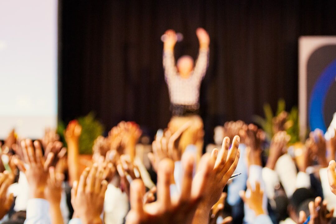 Person confidently presenting to a small audience